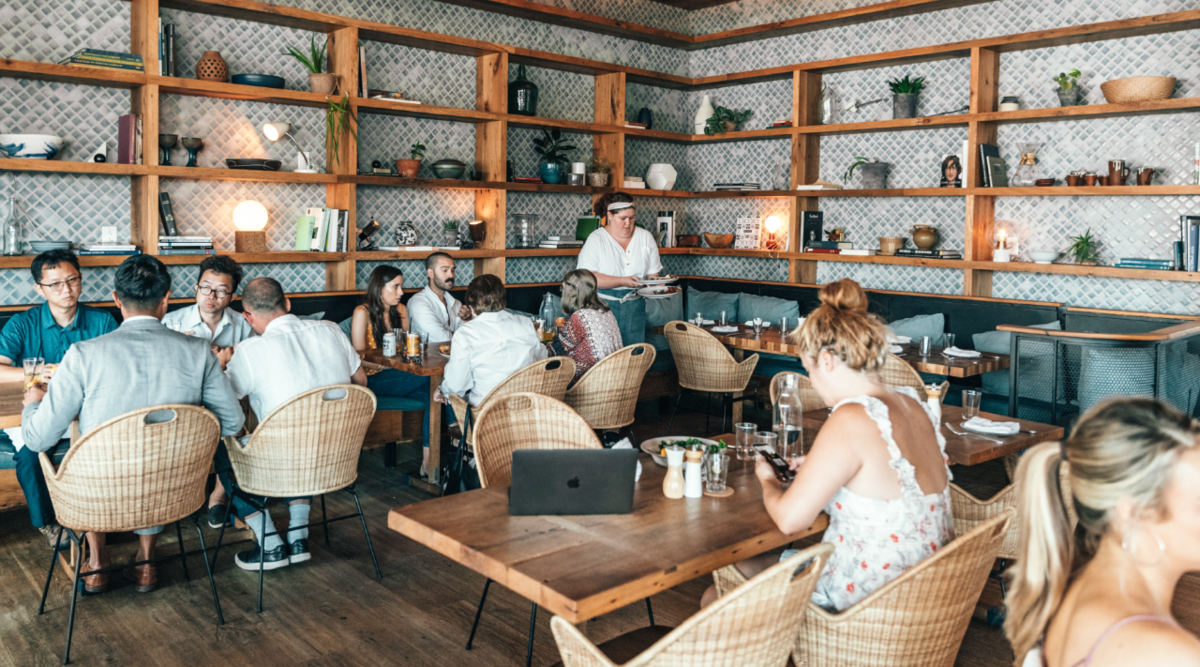 people in busy restaurant enjoying a meal